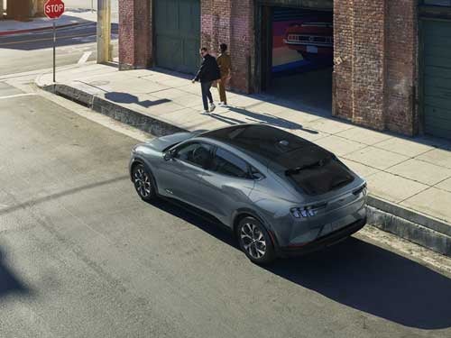 2023 Ford Mustang Mach-E aerial view of vehicle driving down the street showing glass roof