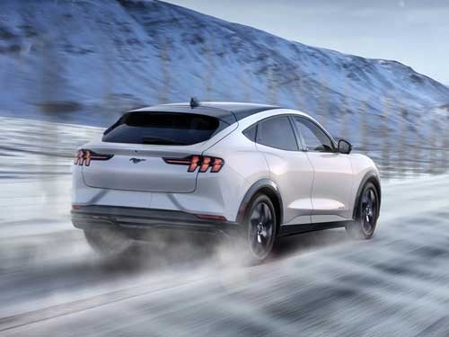 2023 Ford Mustang Mach-E driving fast in the snow