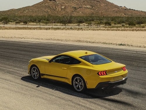 2024 Ford Mustang driving down the road
