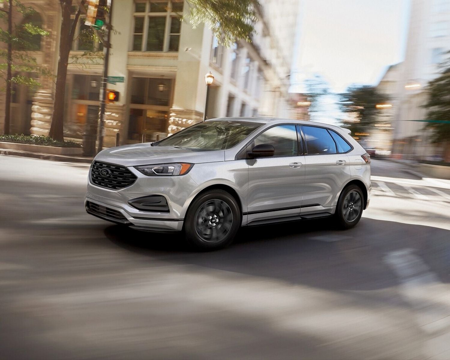 2024 Ford Edge driving on the interstate at sunset