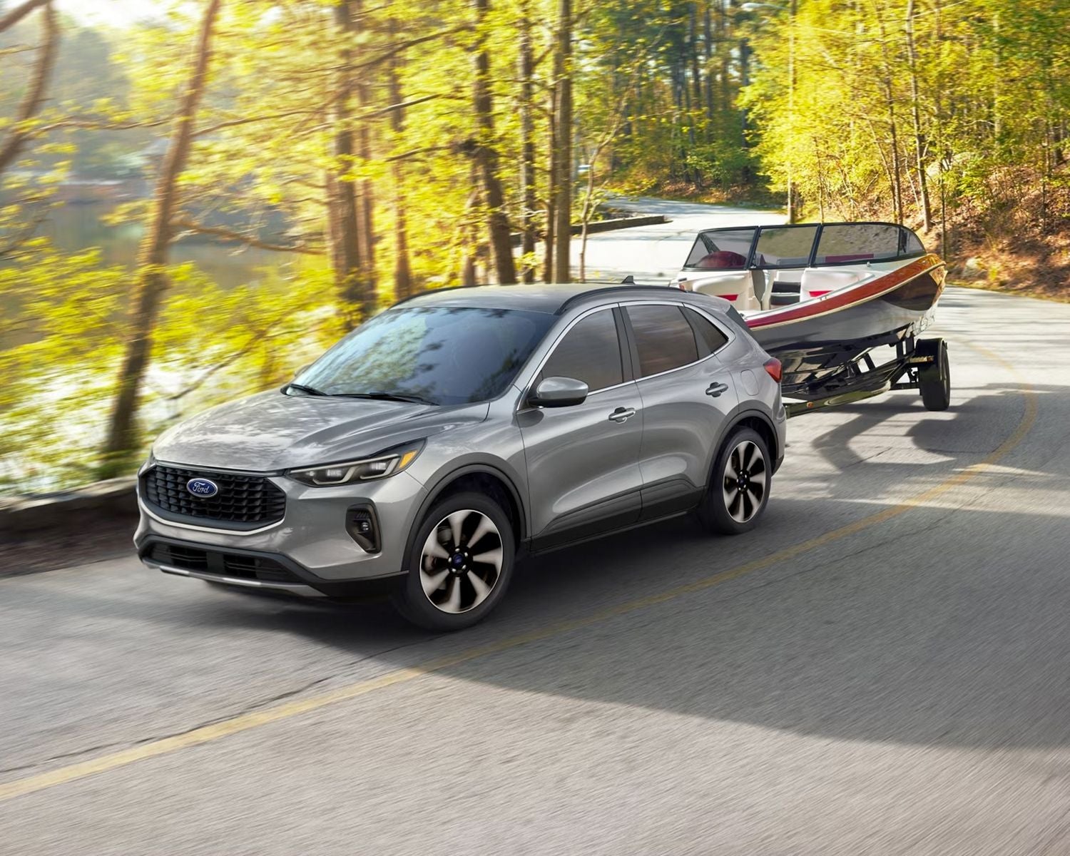 2024 Ford Escape towing a boat down the road 